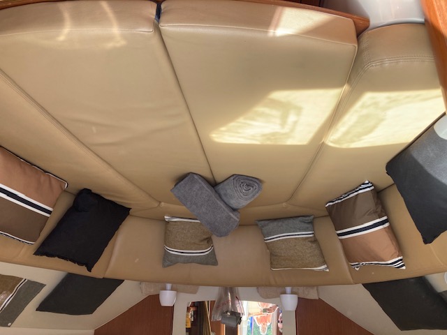 Interior cabin with beige upholstery convertible in double berth